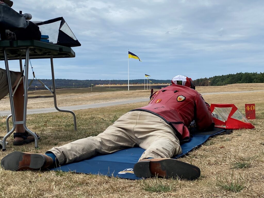 Strong winds shown on the flags in front of a shooter at 1200 yards. 